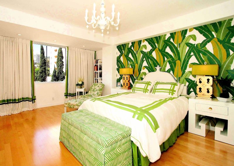 Wall mural with large leaves in the bedroom interior