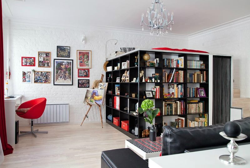 Black shelving in the common room of a studio apartment