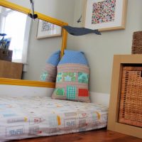 Decorative pillow on a mattress in a children's room