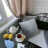 A small glass table on the balcony