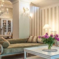 Pink peonies in the living room with striped wallpaper