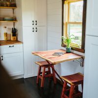 A small folding table in front of the window