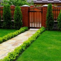 Wooden gate on brick posts