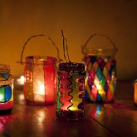 Burning candles inside souvenir cans