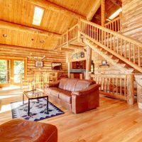 Leather sofa in a spacious living room of a wooden house