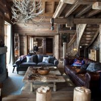 Rough finish of the ceiling and furniture in the living room of a country house