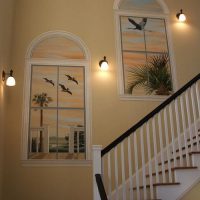 Wall decor on the stairs with false windows