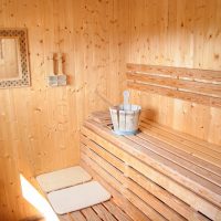 The mirror on the wall of the steam room in the sauna