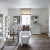 White bath in the center of the room of a private house