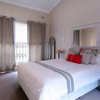 Mirror above the head of the bed in the modern bedroom