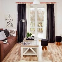 Black curtains in the living room with white walls.