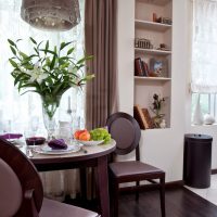 Vase with fresh flowers on the table of the kitchen-living room