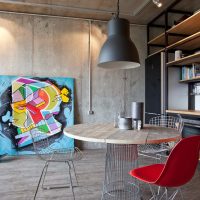 Red chair in front of a round dining table