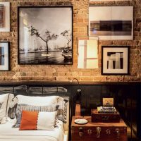 Photos on frames on a brick wall