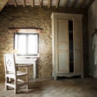 Vintage furniture in a room with stone walls