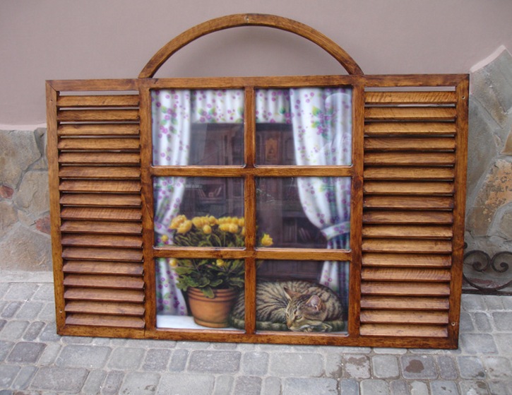 Imitation wooden window with a cat on the windowsill