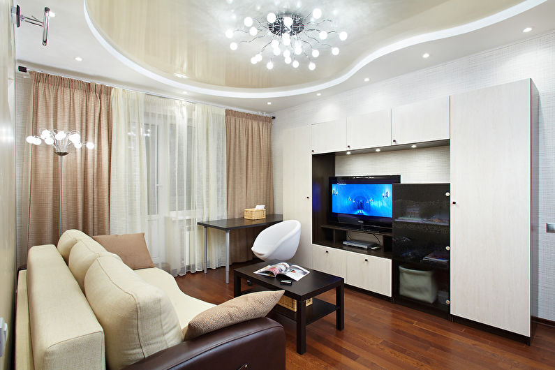 Stretch ceiling with a glossy surface in the living room of a modern apartment