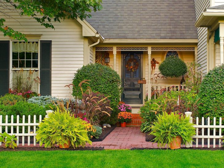 A low wooden fence in front of a country house