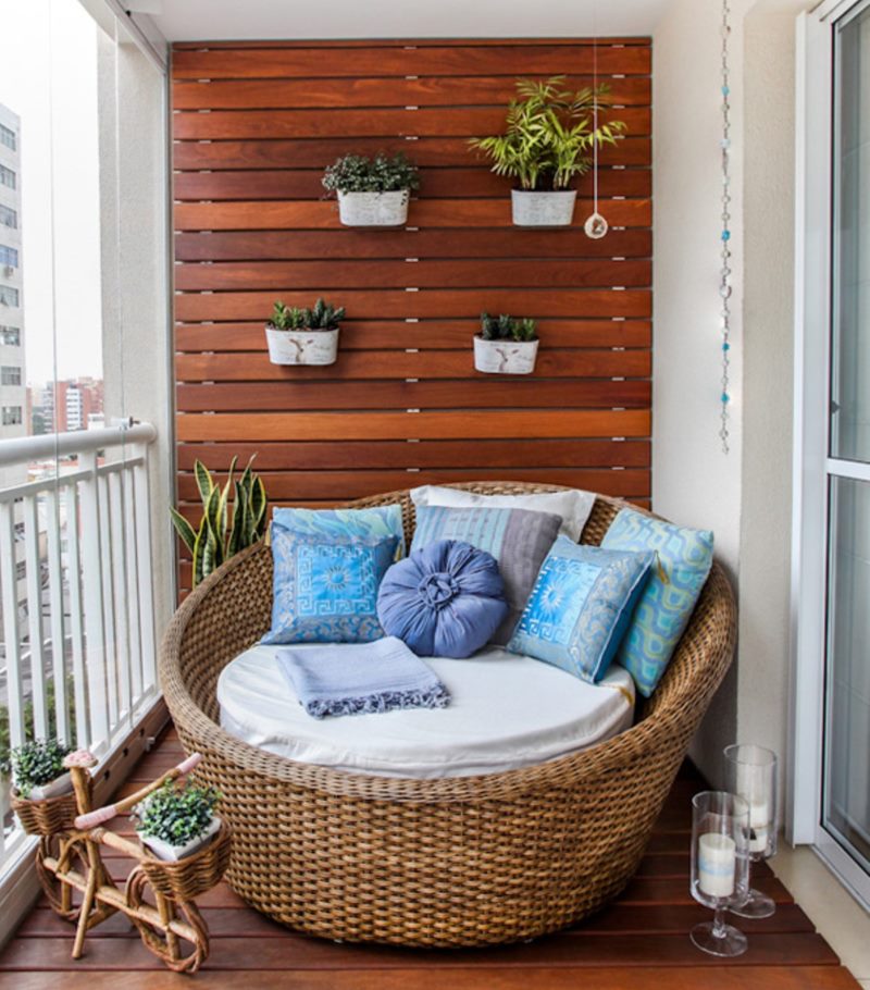 Wicker chair on the wooden floor of an open balcony