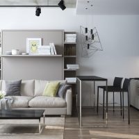 Interior of a studio apartment with a black kitchen