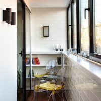 Plastic chairs in the interior of a narrow balcony