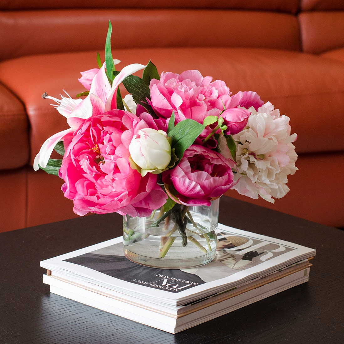 A small bouquet on a stack of magazines