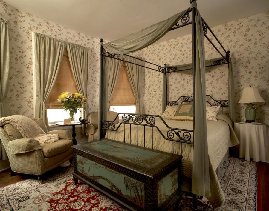 An old chest near a bed in a Victorian bedroom