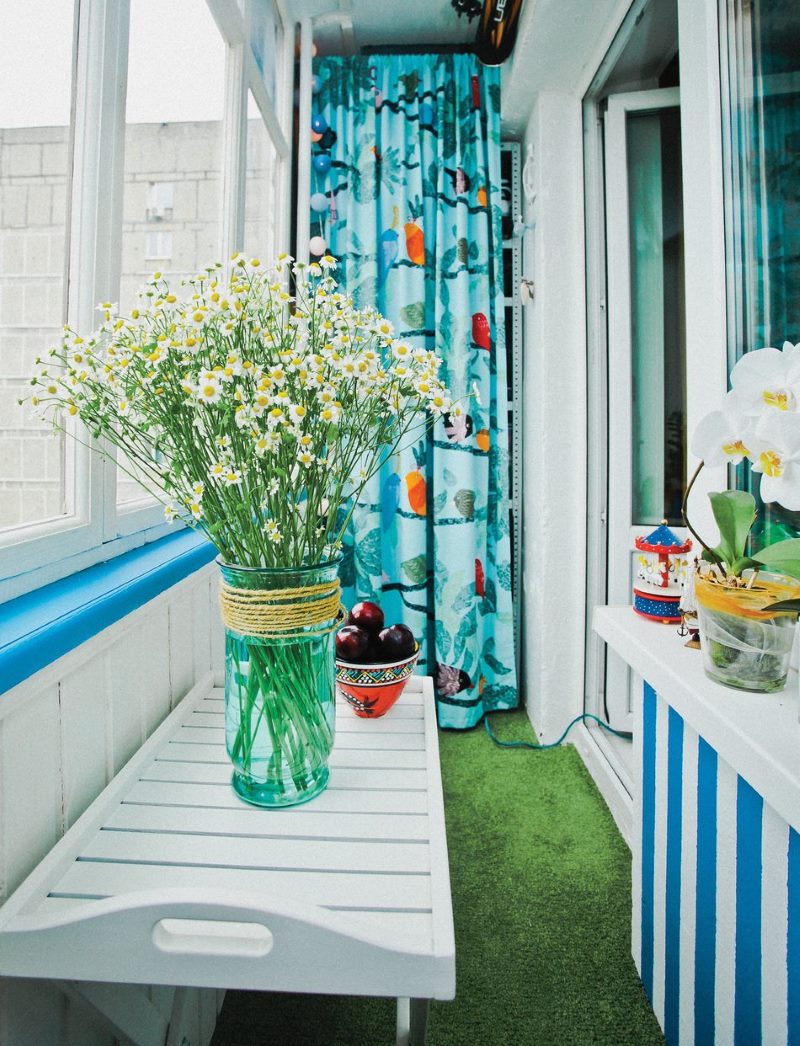 Field daisies on the balcony of a city apartment