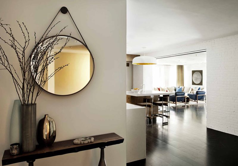 Round pendant mirror in the hallway interior