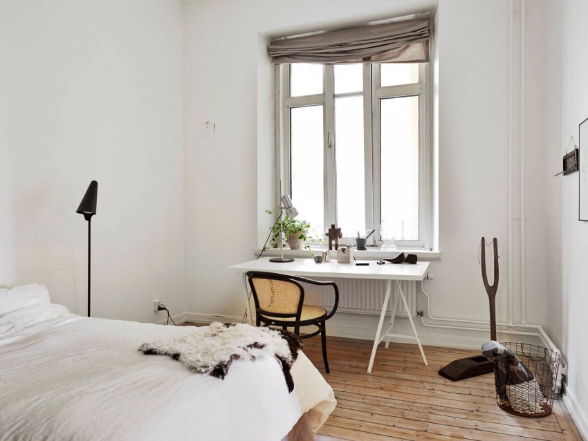 White heating pipes in a Scandinavian style bedroom