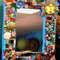 Decor of a mirror frame with beads and pebbles