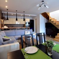 Wooden staircase in the interior of the kitchen-living room