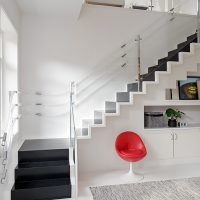 Red armchair against the background of a white wall