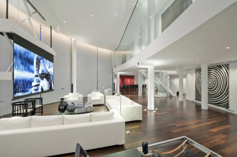 Large television panel on the ground floor of a two-level apartment