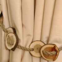 Rope with wooden cuts on a beige curtain