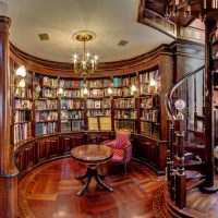 Spiral staircase in the lobby with bookcases.