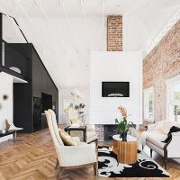 White living room with brick wall.