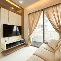 Panoramic window of the living room with translucent curtains