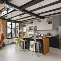 Black beams on the white ceiling of the kitchen