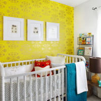 Yellow wallpaper in a nursery for a newborn