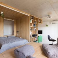 Double bed behind a wooden partition