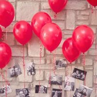 Red balloons with photos of a child