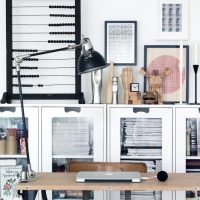 Black abacus on a white wall background