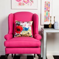 Pink armchair on a striped rug