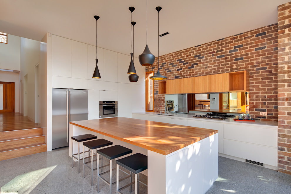 Black lamps on the white ceiling of the kitchen