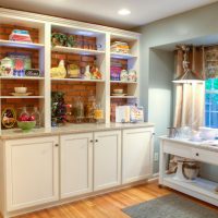 Kitchen cabinet without a back wall along a brick wall