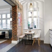 Zoning of the kitchen-living room with a brick partition