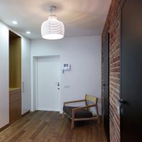 Intercom on a white stairwell wall