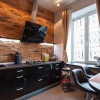 Black furniture in the kitchen without upper cupboards