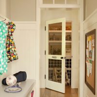 Glass door to the pantry from the narrow corridor